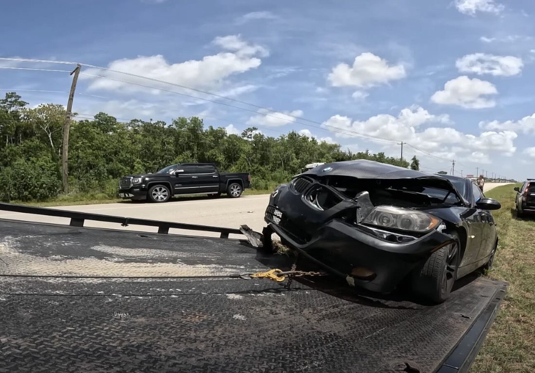 Emergency tow truck recovering damaged vehicle on flatbed in Mount Prospect, IL